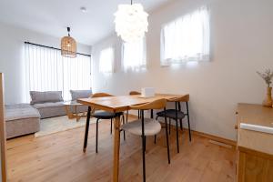 a kitchen and dining room with a table and chairs at Guel Palacio in Miyako-jima