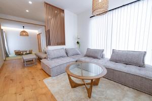 a living room with a couch and a glass table at Guel Palacio in Miyako-jima +36 photos