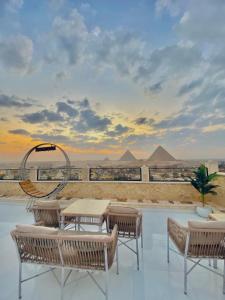 a patio with a table and chairs and pyramids at pyramids fort & free pick up shuttel in Cairo