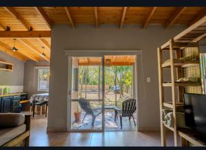 a living room with a sliding glass door to a patio at Tranqueras al Norte in Chascomús