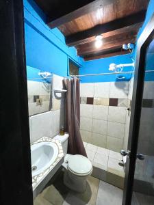 a bathroom with a tub and a toilet and a sink at Onda Hostel Mompiche in Mompiche +30 photos