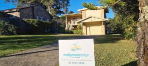 a sign in a yard in front of a house at Beach Dreaming - coastal retreat walk to beach in Mollymook