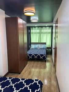 a small room with a bed and a cabinet and a bed sidx sidx at Cozy Baguio House Near Camp John Hay in Baguio