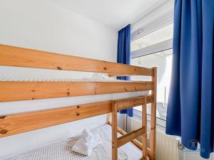 a bunk bed in a room with a window at Lord Nelson Wohnung 118 in Döse +21 photos