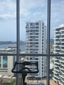 a window with a view of a large building at Nuevo Apartaestudio en frente de la marina in Santa Marta