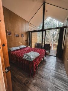 una camera da letto con un letto e una grande finestra di BosqueCielo Cabañas Diseño Natural Arte Galeria a Huasca de Ocampo