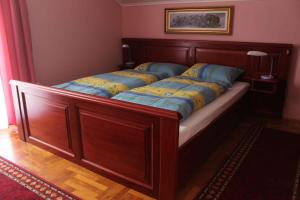 a bed with a wooden frame in a room at Holiday home in Bekesszentandras 20542 in Békésszentandrás