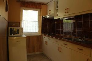 a kitchen with a sink and a microwave at Holiday home in Bekesszentandras 20542 in Békésszentandrás +16 photos