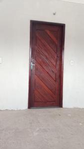 a wooden door in the side of a white wall at Cantinho da Rosa in Santo Amaro +1 photo