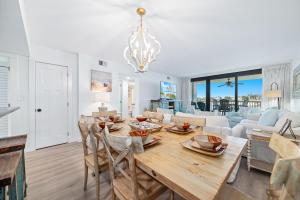a dining room and living room with a table and chairs at Wind Drift North 211-NEW-Bayfront-Beach access-Boat Slips-Sleeps 8 in Orange Beach +51 photos