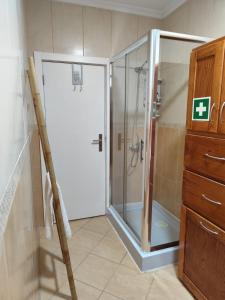 a shower with a glass door in a bathroom at Casa do Retornado in Covas do Barroso +11 photos