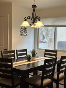 a dining room table with chairs and a chandelier at 2 bedrooms in downtown easy parking in Sacramento +11 photos