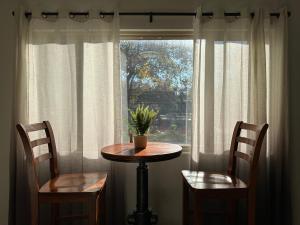 a table and two chairs in front of a window at 2 bedrooms in downtown easy parking in Sacramento