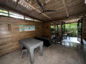 a living room with a table and a couch at Cahuitas red frog house in Talamanca