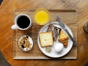 a plate with eggs and toast and a cup of coffee at UNPLAN Kagurazaka in Tokyo