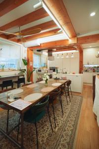 a kitchen and dining room with a long table and chairs at SeoulView Guest House in Seoul