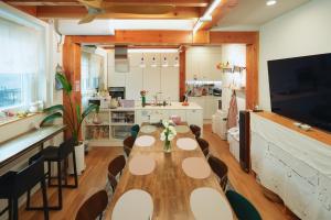 a dining room with a long table and chairs at SeoulView Guest House in Seoul