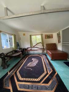 a living room with a rug on the floor at บ้านเพื่อนโฮมสเตย์ เขาพนม2 