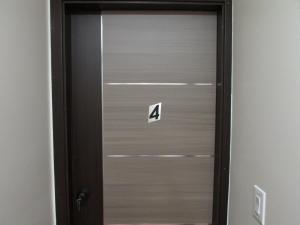a metal door with the number four on it at Cozy Rooms in Ozone Park in Brooklyn Manor