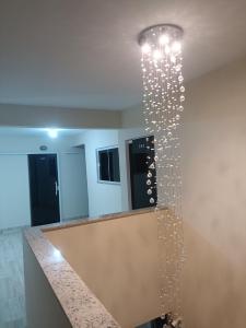a bunch of wine glasses hanging from a wall at Pousada VKG Suites in São Pedro da Aldeia +104 photos