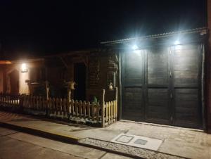 an old house with a wooden door and a fence at Fully furnished 1bedroom apt in the Peruvian Andes in Sangarará +49 photos