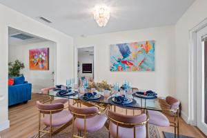 a dining room with a table and chairs at Your own 5BR Private Oasis! wPrivate PoolPickleball in West Palm Beach
