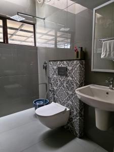 a bathroom with a toilet and a sink at Windy Cove by bukroom in Pīrmed +24 photos