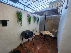 a patio with a grill and a table and chairs at Casa entera, elegante, moderna in Guadalajara +30 photos