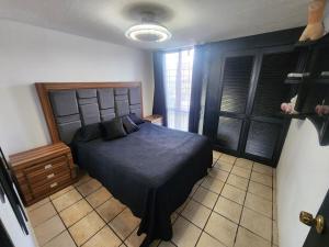 a bedroom with a bed with a blue comforter at Casa entera, elegante, moderna in Guadalajara