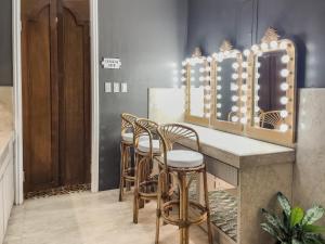 a row of stools at a bar with a mirror at MIRANAMIN NEST Elegant Home, Indoor Plunge Pool, Pet-Friendly, with Rooftop, Kitchens, Self-Service Breakfast - Ideal for Reunions, Team Building, Intimate Gatherings in Manila