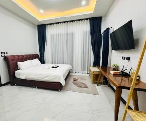 a bedroom with a bed and a desk and a computer at TwoEightsix 286 Poolvilla in Ban Khun Thale