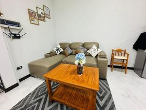 a living room with a couch and a coffee table at TwoEightsix 286 Poolvilla in Ban Khun Thale