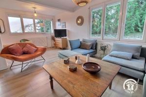 a living room with a couch and a table at St christophe in Lézardrieux