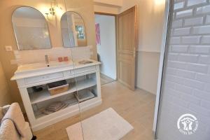 a bathroom with a sink and a mirror at St christophe in Lézardrieux +36 photos