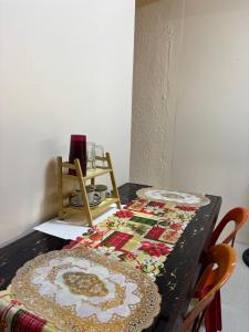 a table with a quilt on top of it at Maru Vibe Guest house at Panicsican San Juan Elyu in San Juan