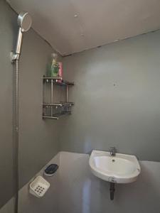 a small bathroom with a sink and a shower at Maru Vibe Guest house at Panicsican San Juan Elyu in San Juan