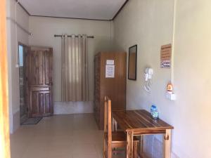 a room with a wooden table and a telephone at XAIYASITH guesthouse in Nongkhiaw