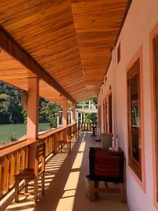 a porch of a house with a wooden ceiling at XAIYASITH guesthouse in Nongkhiaw
