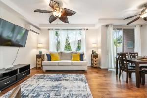 a living room with a white couch and a tv at Luxury Villa Paradise Home in Honokai Hale