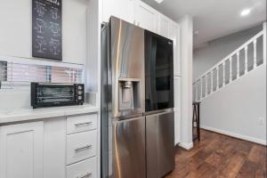 a kitchen with a stainless steel refrigerator and a microwave at Luxury Villa Paradise Home in Honokai Hale +18 photos