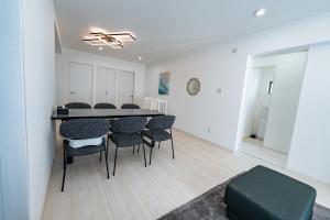 a living room with a dining room table and chairs at Villa Nuunu in Miyako-jima