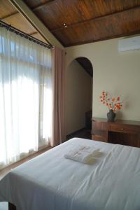 Ένα ή περισσότερα κρεβάτια σε δωμάτιο στο Cheers Ecolodge Du Già