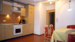 a kitchen with a table and a kitchen with a table and a table at Landhaus Suntheim in Wertach +11 photos