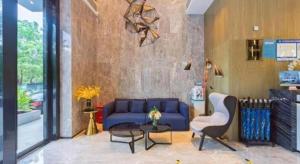 un soggiorno con un divano blu e un tavolo di Echarm Hotel Nanjing Jiangning Tianyin Avenue Metro Station a Fangshan