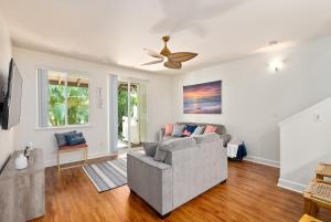a living room with a couch and a ceiling fan at Luxury Oasis Resort Villa in Honokai Hale