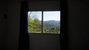 a window in a room with a view of a mountain at Wandritu in Río Ceballos