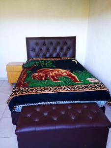 a bed with a blanket on top of it at Wandritu in Río Ceballos