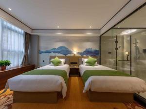 Ένα ή περισσότερα κρεβάτια σε δωμάτιο στο Shell Hotel Anhui Huaibei Railway Station Huiyuan Road