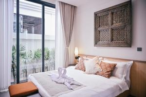 Ένα ή περισσότερα κρεβάτια σε δωμάτιο στο Étoile Kata Luxury Pool Villas by Astra +25 φωτογραφίες