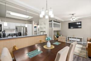 a dining room and kitchen with a table and chairs at Serene Oasis - Home Away from Home in Honokai Hale